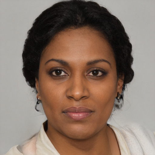 Neutral black young-adult female with medium  brown hair and brown eyes