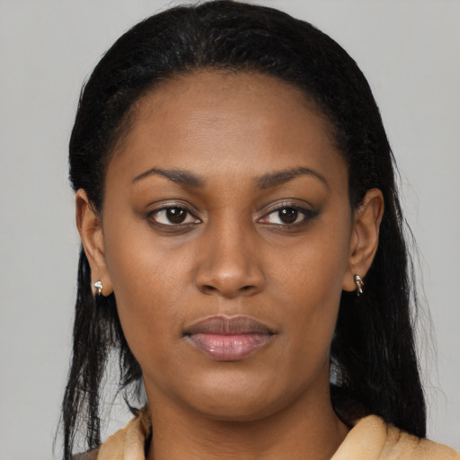 Joyful black young-adult female with long  black hair and brown eyes