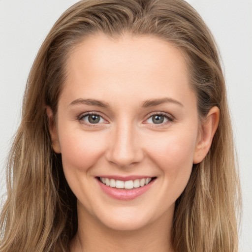 Joyful white young-adult female with long  brown hair and grey eyes