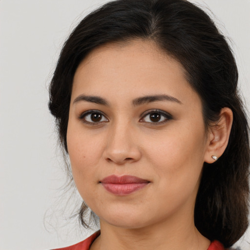 Joyful latino young-adult female with medium  brown hair and brown eyes