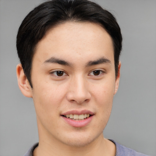 Joyful asian young-adult male with short  brown hair and brown eyes