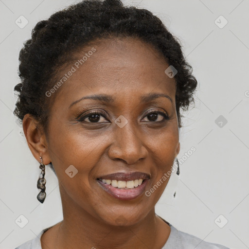 Joyful black adult female with short  brown hair and brown eyes