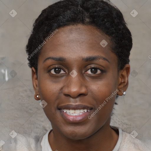 Joyful black young-adult female with short  brown hair and brown eyes