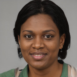 Joyful black young-adult female with medium  brown hair and brown eyes