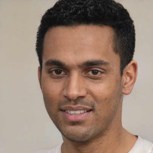 Joyful white young-adult male with short  black hair and brown eyes