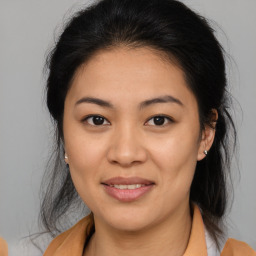 Joyful asian young-adult female with medium  brown hair and brown eyes