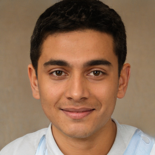 Joyful latino young-adult male with short  brown hair and brown eyes