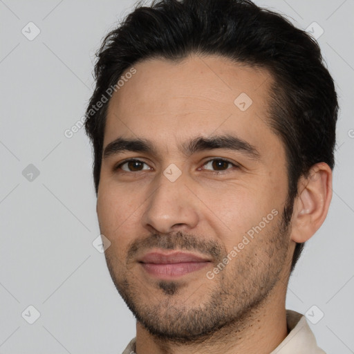 Joyful white young-adult male with short  black hair and brown eyes