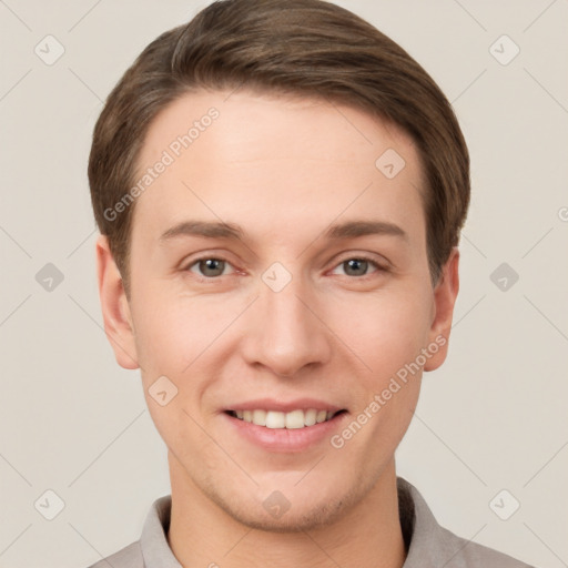 Joyful white young-adult male with short  brown hair and grey eyes