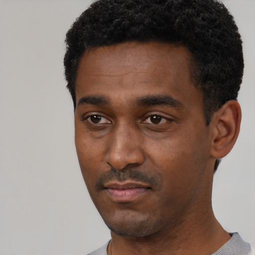 Neutral black young-adult male with short  black hair and brown eyes
