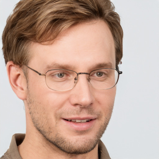 Joyful white adult male with short  brown hair and grey eyes