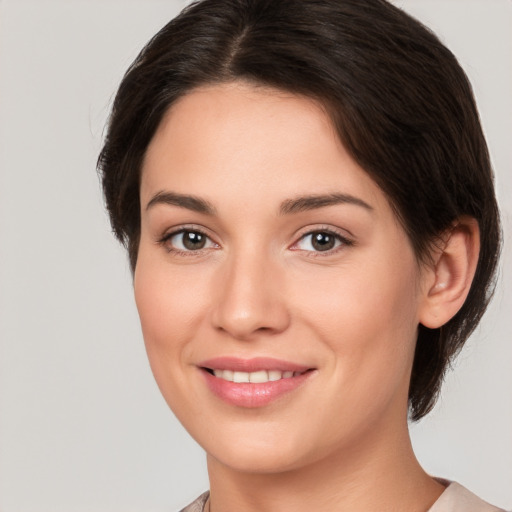 Joyful white young-adult female with medium  brown hair and brown eyes