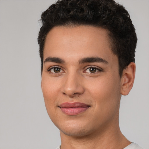 Joyful white young-adult male with short  black hair and brown eyes