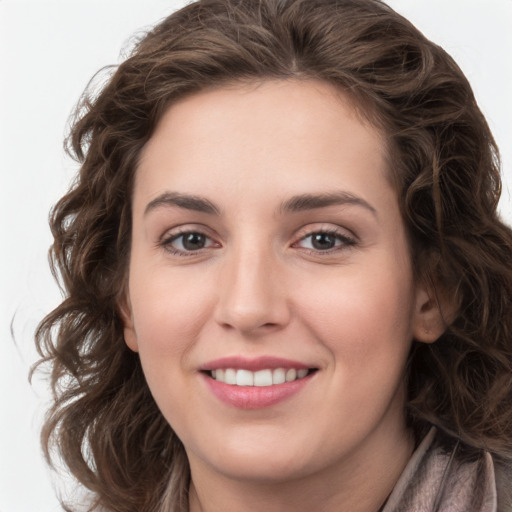 Joyful white young-adult female with medium  brown hair and green eyes