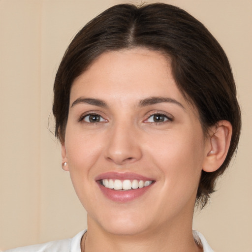 Joyful white young-adult female with medium  brown hair and brown eyes