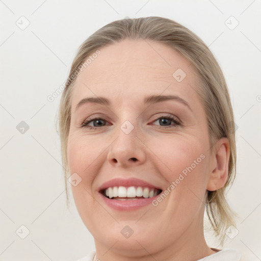 Joyful white young-adult female with medium  brown hair and blue eyes