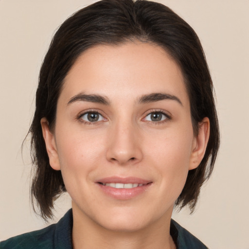 Joyful white young-adult female with medium  brown hair and brown eyes