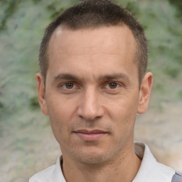 Joyful white adult male with short  brown hair and brown eyes