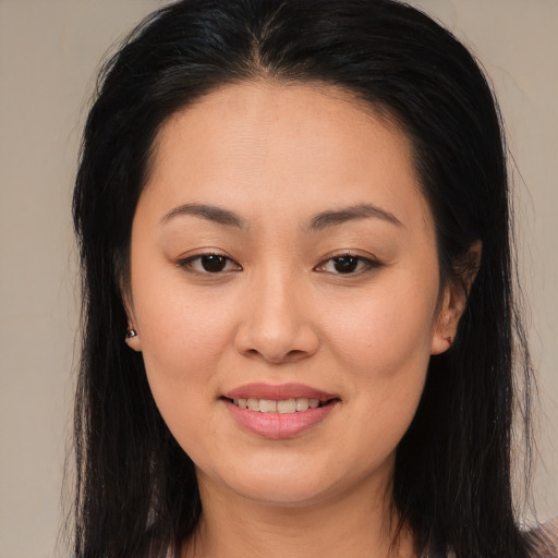 Joyful asian young-adult female with long  brown hair and brown eyes