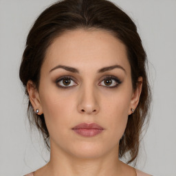 Neutral white young-adult female with medium  brown hair and brown eyes