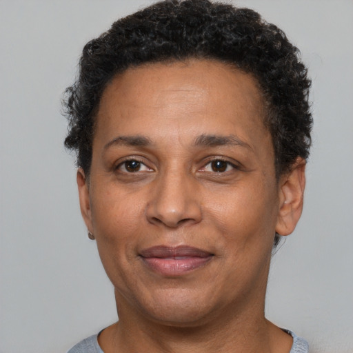 Joyful black adult female with short  brown hair and brown eyes