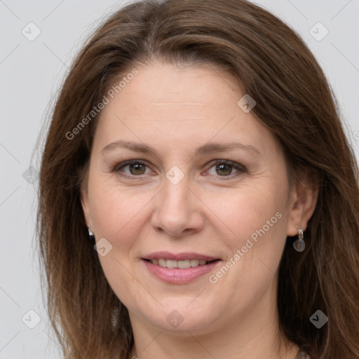 Joyful white adult female with long  brown hair and grey eyes