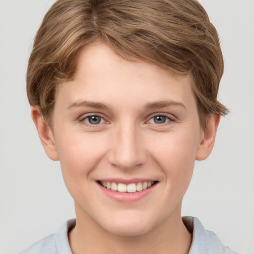 Joyful white young-adult female with short  brown hair and grey eyes