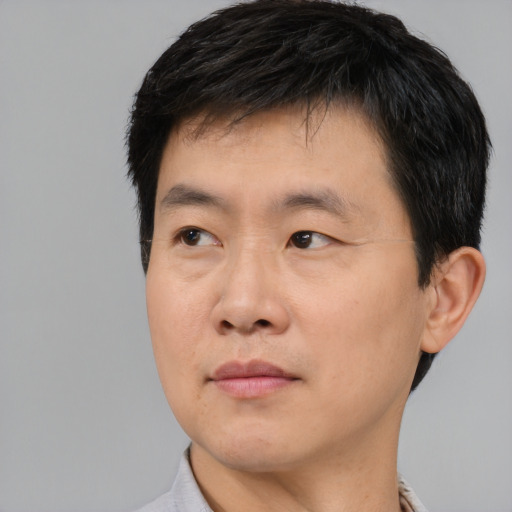 Neutral asian young-adult male with short  brown hair and brown eyes