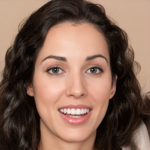 Joyful white young-adult female with long  brown hair and brown eyes