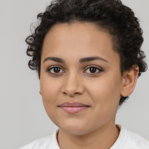 Joyful latino young-adult female with short  brown hair and brown eyes