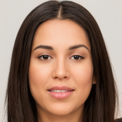 Joyful latino young-adult female with long  brown hair and brown eyes