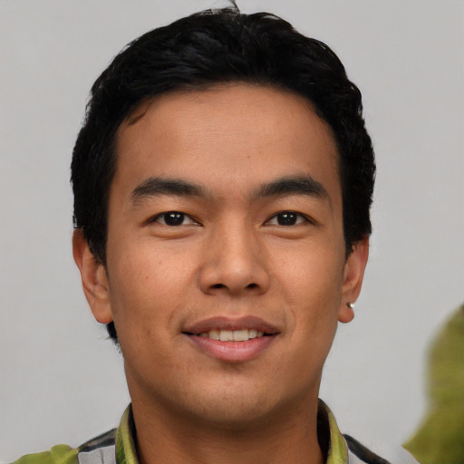 Joyful white young-adult male with short  black hair and brown eyes