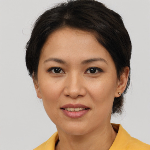 Joyful asian young-adult female with medium  brown hair and brown eyes