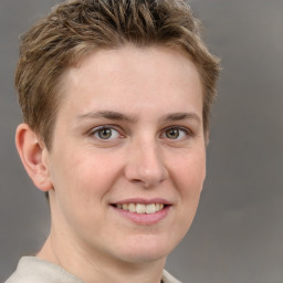 Joyful white young-adult female with short  brown hair and grey eyes