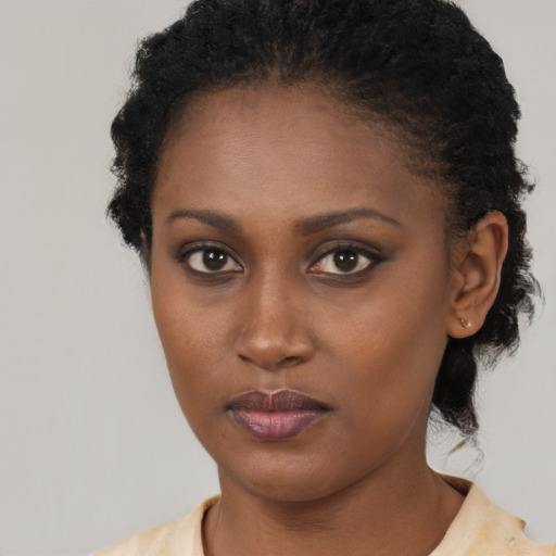 Neutral black young-adult female with short  brown hair and brown eyes