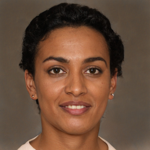 Joyful latino young-adult female with short  brown hair and brown eyes