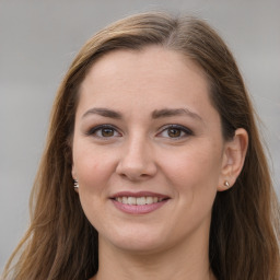 Joyful white young-adult female with long  brown hair and grey eyes