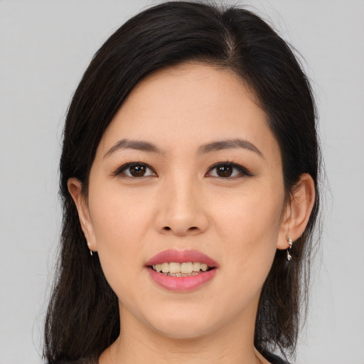 Joyful asian young-adult female with medium  brown hair and brown eyes