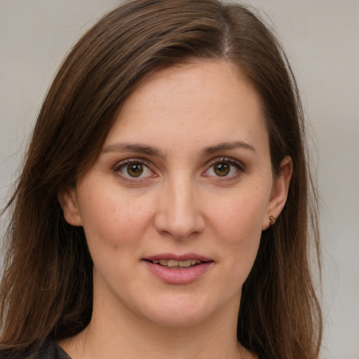 Joyful white young-adult female with long  brown hair and brown eyes