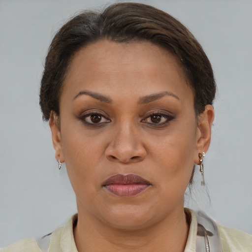Joyful latino adult female with short  brown hair and brown eyes