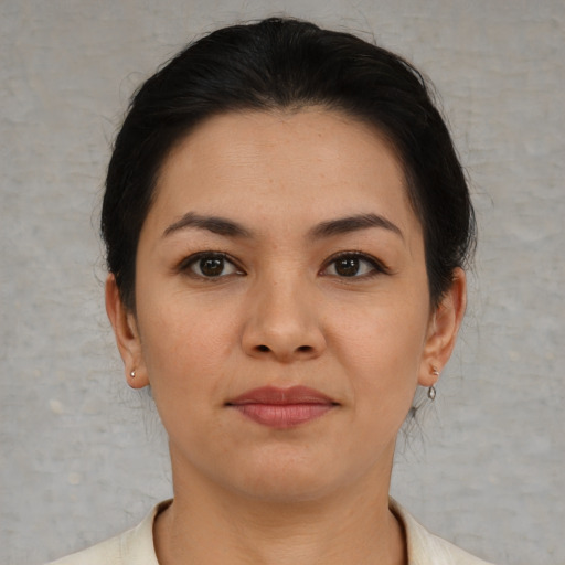 Joyful asian young-adult female with short  brown hair and brown eyes