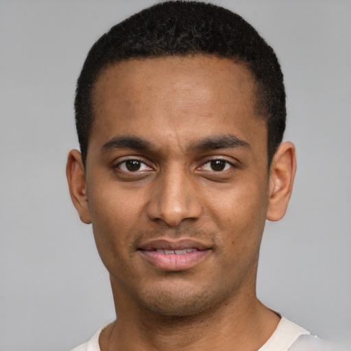 Joyful black young-adult male with short  brown hair and brown eyes