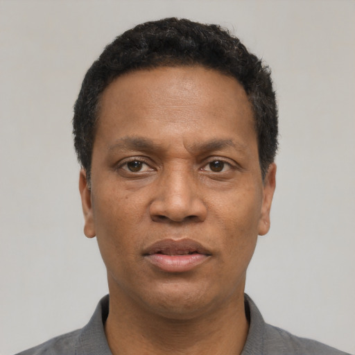 Neutral latino adult male with short  black hair and brown eyes