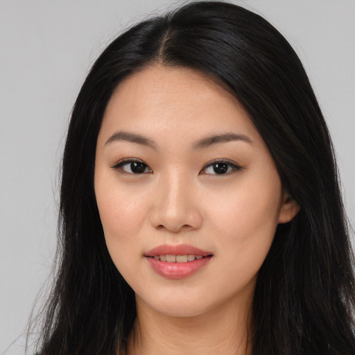 Joyful asian young-adult female with long  black hair and brown eyes
