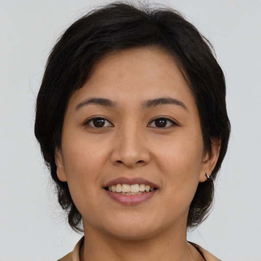 Joyful asian young-adult female with medium  brown hair and brown eyes