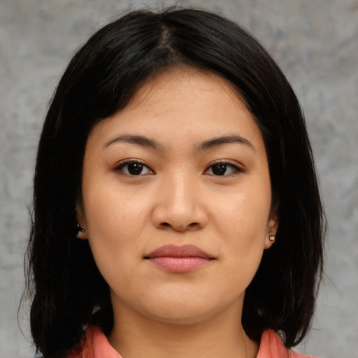 Joyful asian young-adult female with medium  black hair and brown eyes