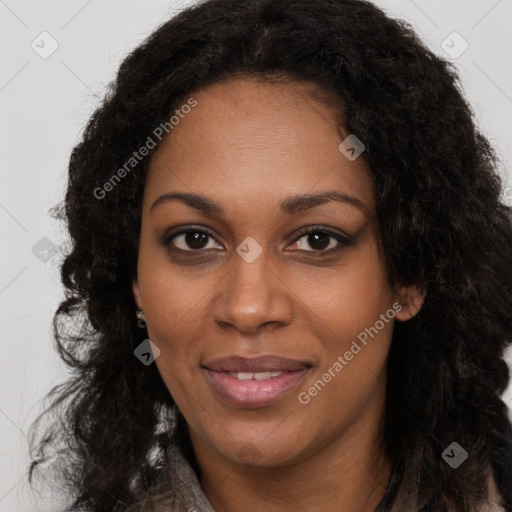 Joyful black young-adult female with long  brown hair and brown eyes