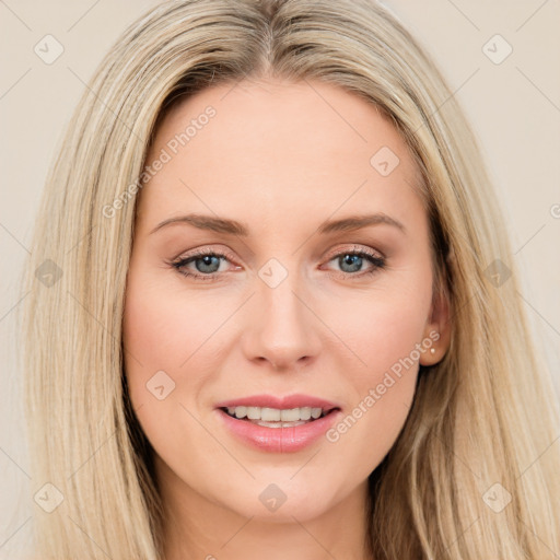 Joyful white young-adult female with long  brown hair and blue eyes