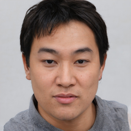 Neutral asian young-adult male with short  black hair and brown eyes