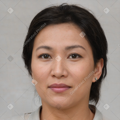 Joyful latino adult female with medium  brown hair and brown eyes